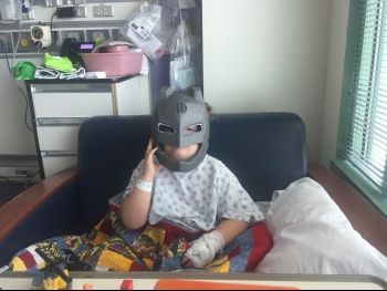 Child at Shriners Hospital enjoying the donation of toys